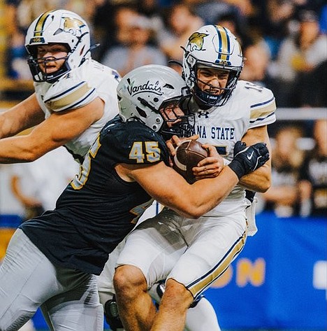 IDAHO ATHLETICS
Mitchel Jaskowiak (45) of Idaho puts a hit on Montana State quarterback Patrick Duchien (15) in the first half Friday at the P1FCU Kibbie Dome in Moscow.