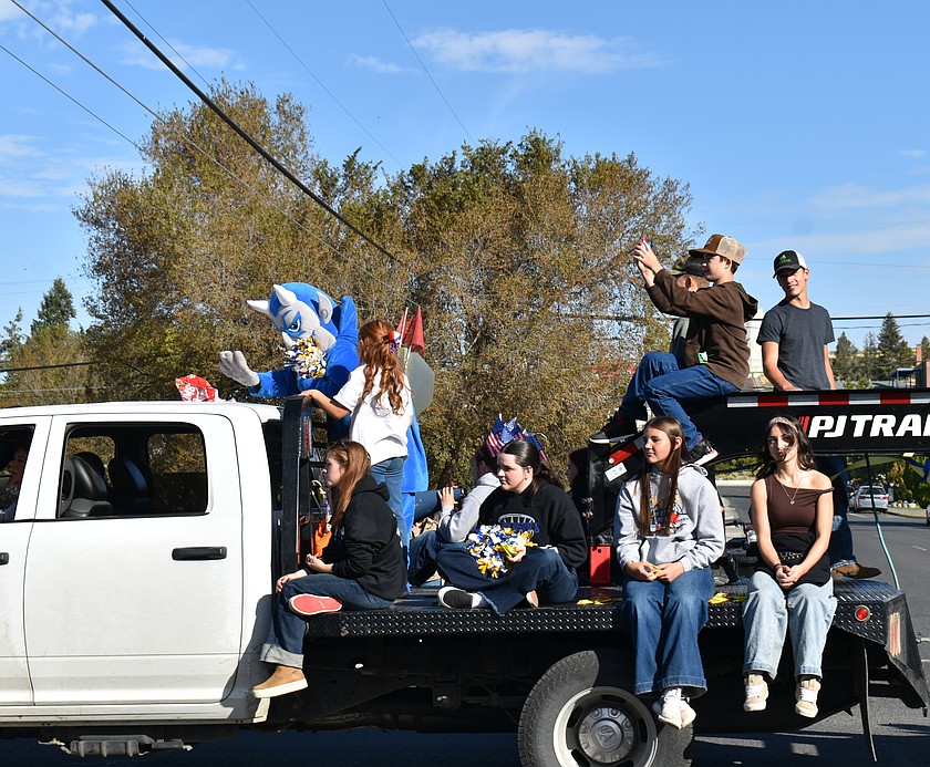 The Wilson Creek Devil leads students from Wilson Creek High School in chants and cheers in the Harvest Festival parade Saturday.