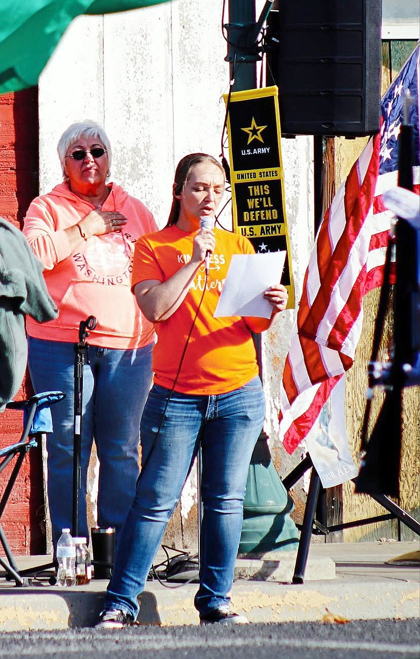 Paisley Schabel sings the national anthem to kick off the parade at Wilson Creek Harvest Festival Saturday.