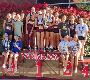 After competing in the Girls Varsity Gold Division Moses Lake girls hold up their first-place trophy with Ephrata their second-place trophy at the Sunfair Invitational.