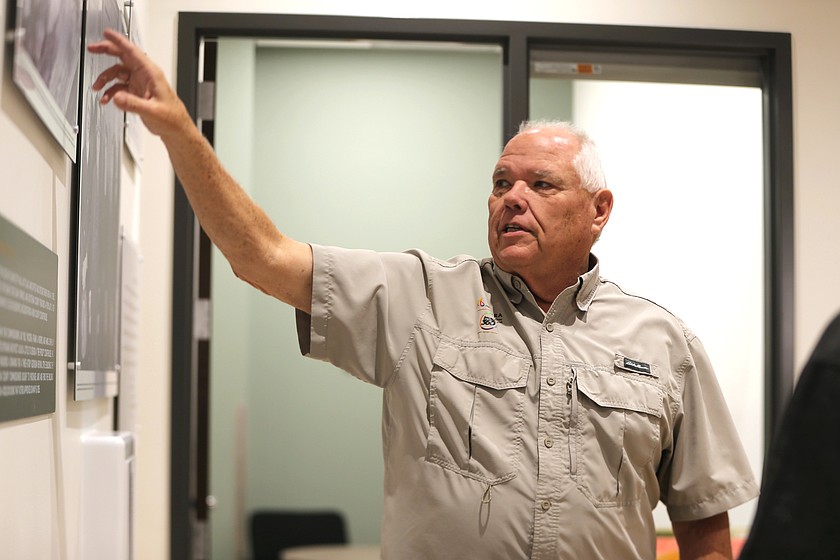 Roger Stewart points out an element of an exhibit showing Kootenai County's history. Stewart's business, Allegra Coeur d'Alene, designed and installed the exhibit in the Justice Building downtown.