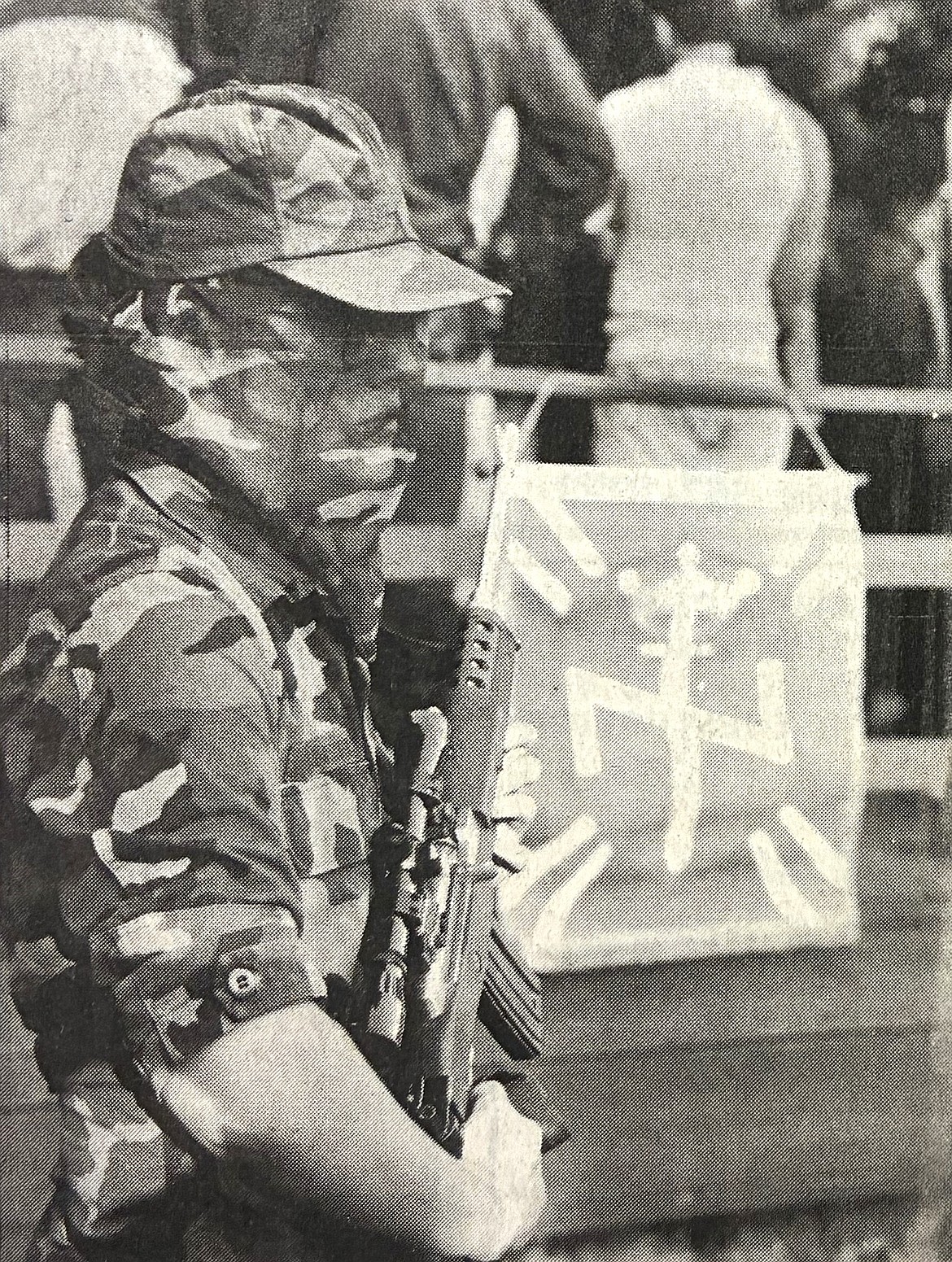 In July 1986, a racist guard, armed with an automatic rifle, watched a press conference at the annual Aryan Nations World Congress, near Hayden Lake.
