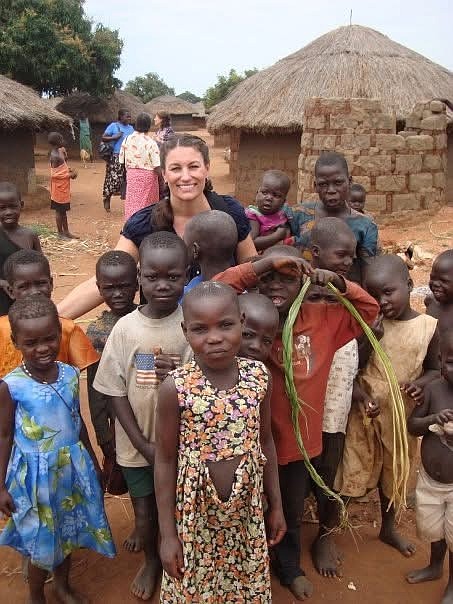 Linda Coppess in northern Uganda at an IDP (Internally Displaced Person) camp with local children.