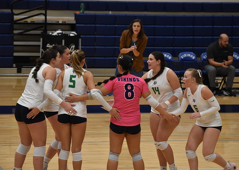 Vikings players huddle together after a point during Wednesday’s game against the Yaks.