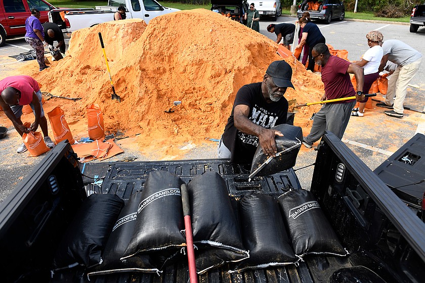 Residents pick up sandbags for storm preparation at the James Seals Jr. Parks & Recreation Center ahead of Hurricane Isaias' expected landfall along the Gulf Coast, Thursday, Oct. 8, 2026, in Mobile, Ala. (AP Photo/Octavio Jones)
