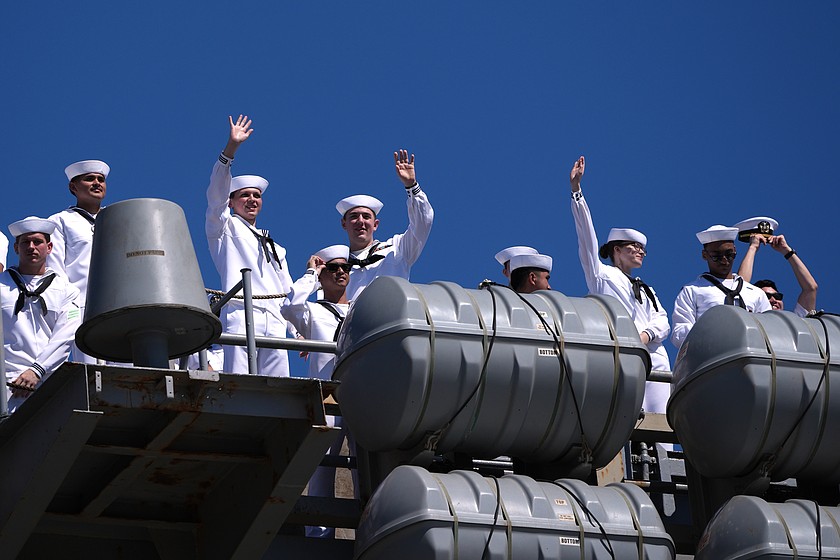 Sailors wave aboard the USS Abraham Lincoln aircraft carrier as it returns to Naval Air Station North Island after deployment Thursday, Oct. 8, 2026, in Coronado, Calif. (AP Photo/Gregory Bull)