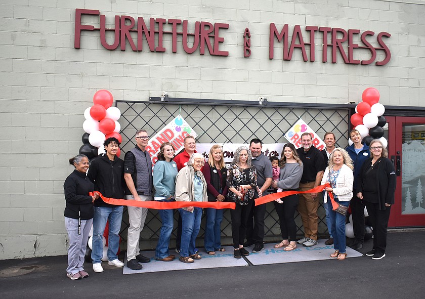 Wendy and Ron Cox, owners of The Home Center in Moses Lake, cut the ceremonial ribbon to celebrate taking official ownership of the store, accompanied by members of the Moses Lake Chamber of Commerce.
