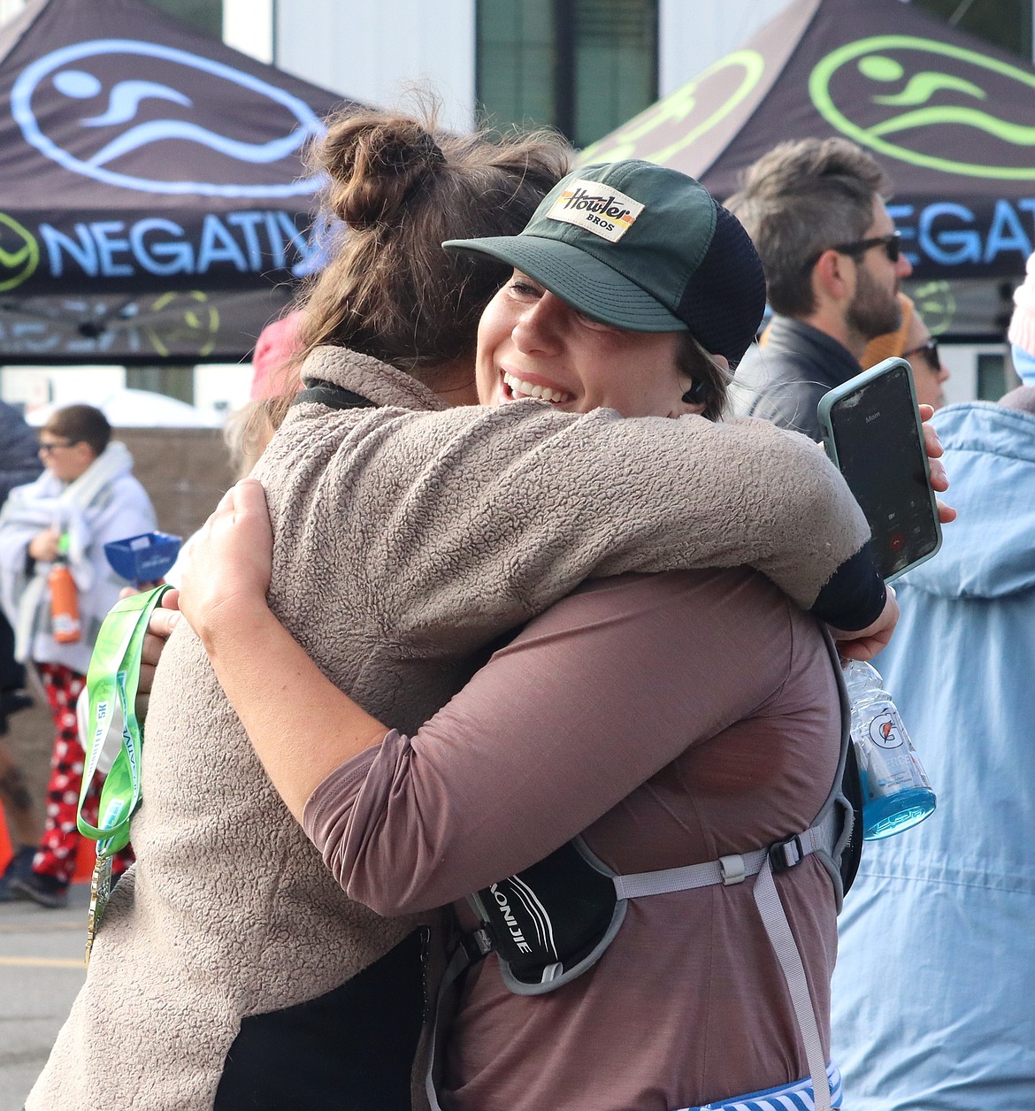 Danae Koeske of Spokane gets a hug after finishing the Hayden Lake half marathon.