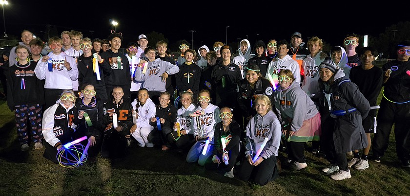 The Ephrata Tigers cross country team gathers for a photo following the Neon Nights meet in Selah. The Tigers girls finished first and the boys took second in their 5K events.