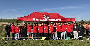 The Othello Huskies cross country team’s coaches and athletes stand together for a group photo ahead of a previous meet this year. The team is partnering with Pillar Fitness and Les Schwab of Othello for their first annual Harvest Hustle.