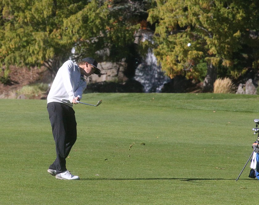 MARK NELKE/Press
Coeur d'Alene junior Hunter Paquin hits his approach shot on the ninth hole during the first round of the state 6A golf tournament Monday at Avondale Golf Club in Hayden.