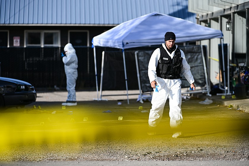 Kalispell Police Department investigators work at the scene of a homicide where multiple people were shot at an apartment complex in the 100 block of Seventh Avenue East North in Kalispell on Tuesday, Oct. 13. (Casey Kreider/Daily Inter Lake)
