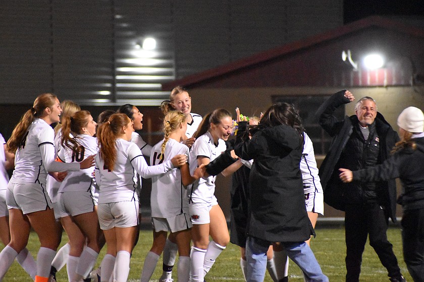 The Ephrata Tigers team rushes the field to celebrate the game winning goal in overtime Tuesday against the Othello Huskies.