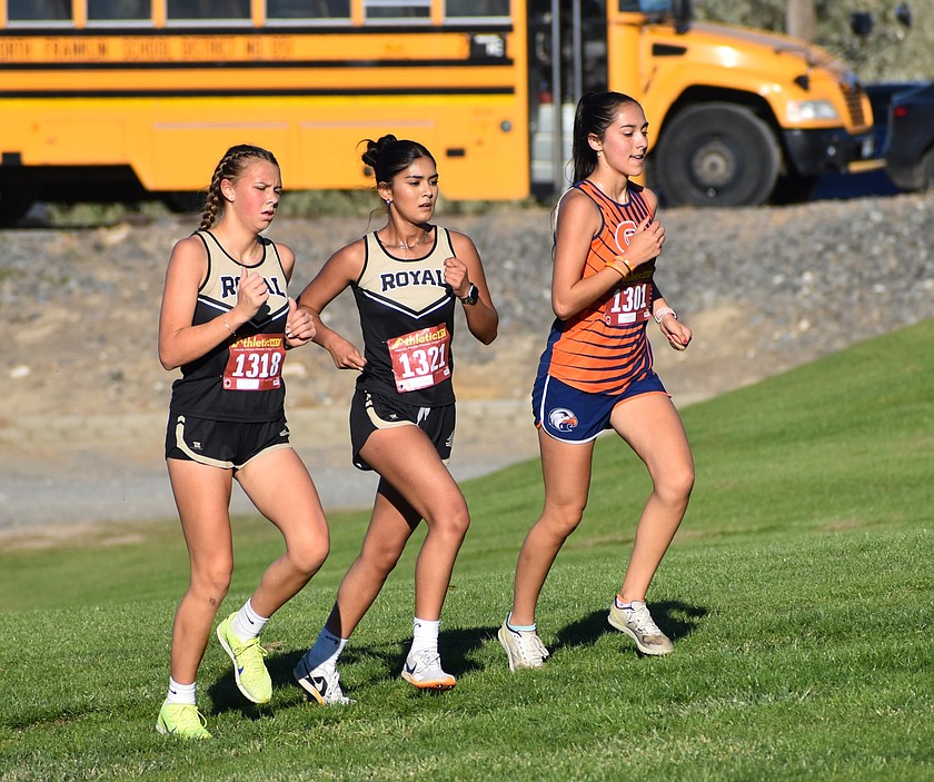 Royal freshman Brooklyn Orth and senior Valeria Rodriguez run side by side during Wednesday’s meet.