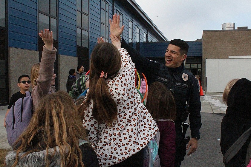 The Moses Lake School District is hosting a town hall at 6 p.m. Tuesday, Oct. 20 at the Learning Services Center to discuss school safety. Pictured is school resource officer Roland Alejo high-fiving students at Groff Elementary.