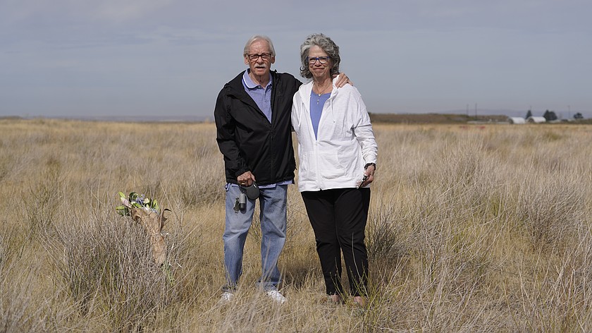 Michael (left) and Carol Hawk left flowers at the site of the 1950 Larson Air Force Base crash that killed Michael's dad Leonard.