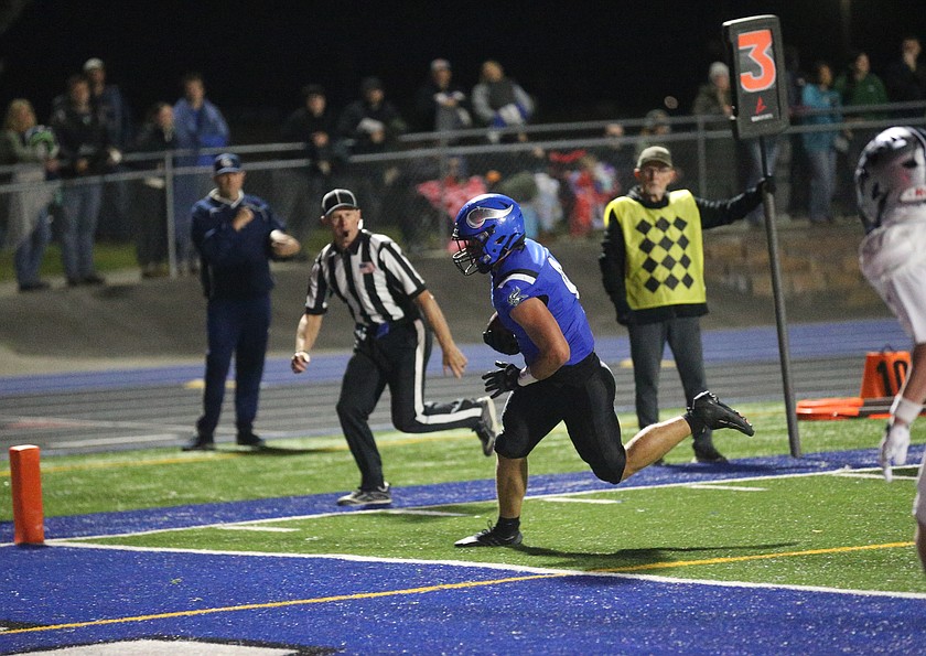MARK NELKE/Press
Coeur d'Alene junior Logan Melville (9) scores on a 6-yard touchdown reception in the first quarter against Lake City on Friday night at Viking Field.