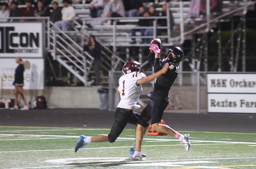 The Knights’ Manny Ruvalcaba (8) hauls in a contested catch before turning up the field for a 45-yard touchdown.