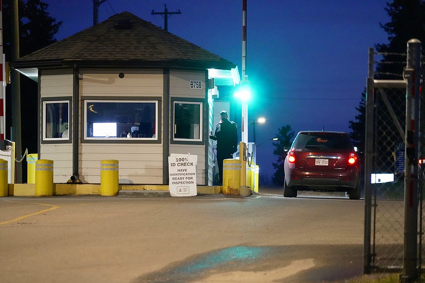 In this photo taken with a smart phone, a car drives through a security booth at the entrance to Canadian Forces Base Wainwright in Alberta, Canada, Monday, Oct. 18, 2026. (AP Photo/Ty O'Neil)