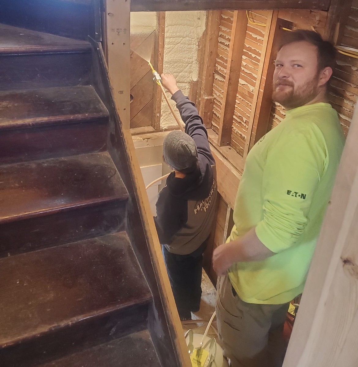Orr's son Caleb and friend Patrick Wilson apply spray foam as part of restoring the Blackwell House.