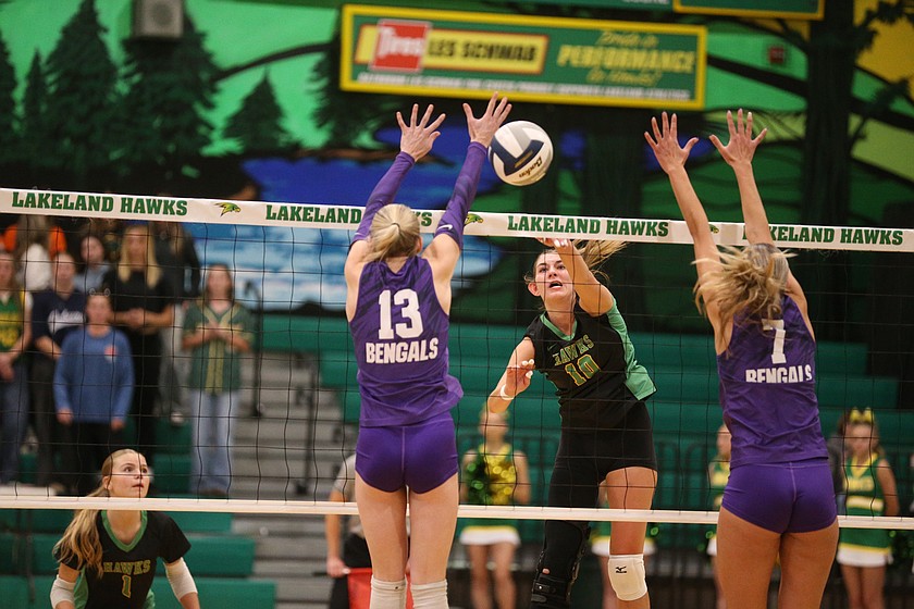 MARK NELKE/Press
Lakeland senior Kindell Day (10) hits between the block of junior Elle Walker (13) and junior Rena Stanger (7) of Lewiston during the 5A Region 1 volleyball championship match Tuesday night at Hawk Court in Rathdrum.