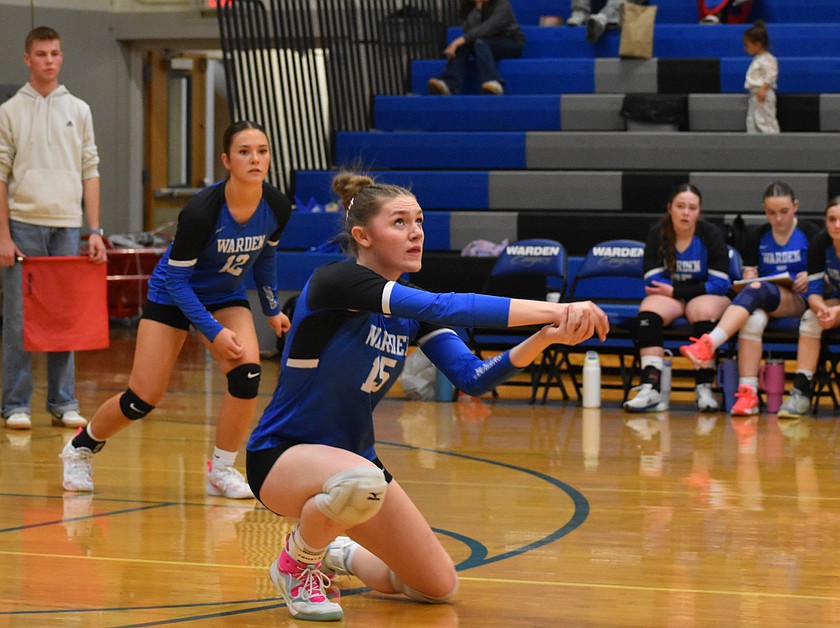 Hannah Roylance, a senior from the Cougars, kneels as she hits the ball up Tuesday evening while her teammate junior Jade Hymas watches on.
