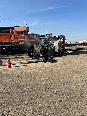 A Warden man was injured when the tractor-trailer he was driving was hit by a train Tuesday in Bruce.