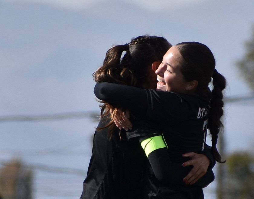 Huskies senior Brooklyn Hillman and junior Khloe Valdez embrace after Hillman's first goal in Saturday's victory over Prosser.