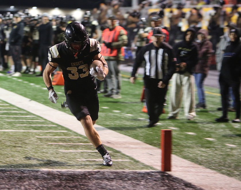 The Knights' Jackson Flood (33) crosses the goal line after outrunning the Connell defense for a touchdown.