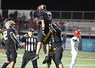 The Mavs' Case Anderson (5) is swarmed by teammates after hauling in a passing touchdown from Nolan Decubber.