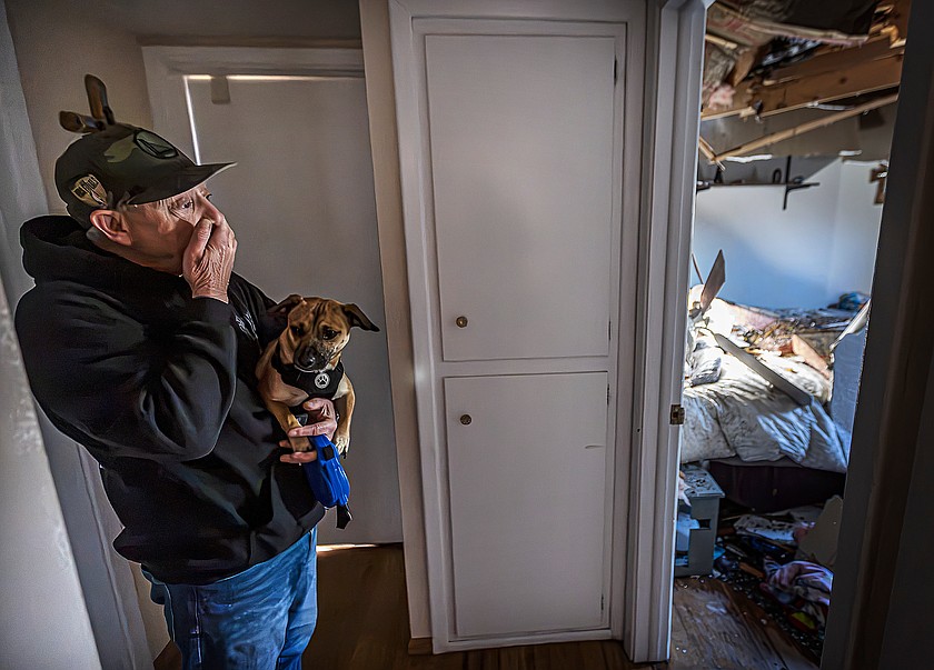 Gary Delgado looks at damage of his home including the partially collapsed roof in Santa Fe, N.M., Sunday, Oct. 25, 2026, following a tornado that touched down in central Santa Fe on Saturday night. (Jim Weber/Santa Fe New Mexican via AP)