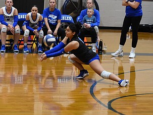 Lidia Rodriguez (8) from the Soap Lake Eagles dives to the floor to make a dig against Wilson Creek.