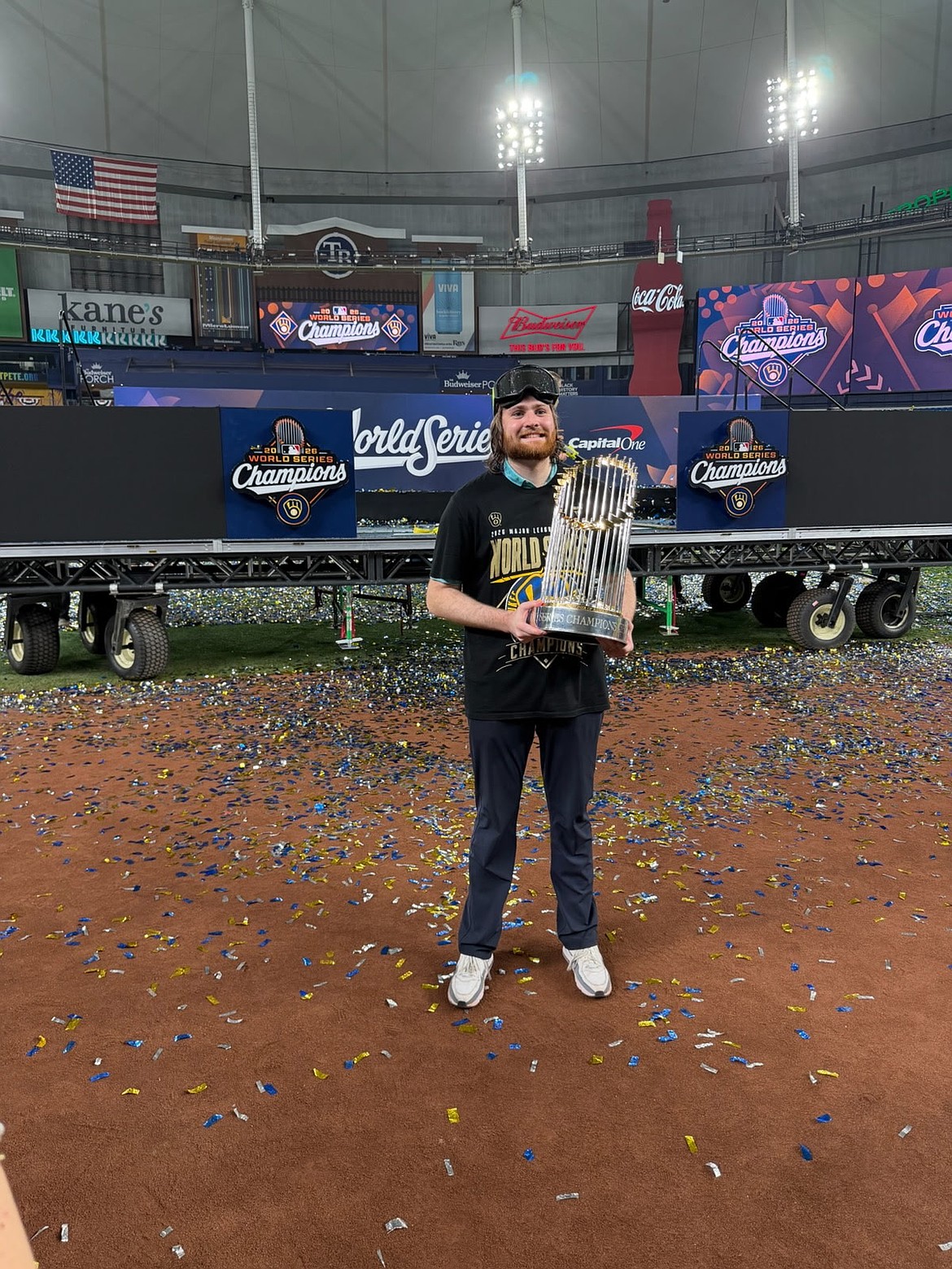 James Armstrong, a Milwaukee Brewers scout who has a family tie to Coeur d'Alene, hoists the World Series Commissioner's Trophy in Tampa Bay on Wednesday evening.